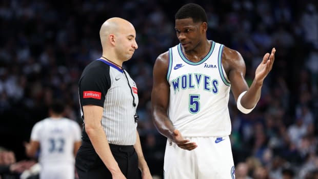 Mar 3, 2024; Minneapolis, Minnesota, USA; Minnesota Timberwolves guard Anthony Edwards (5) talks to referee Aaron Smith (51) during the first half against the LA Clippers at Target Center. 