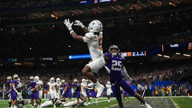Texas Longhorns wide receiver Adonai Mitchell (5) makes a touchdown catch over Washington cornerback Elijah Jackson during the Sugar Bowl College Football Playoff semifinals game at the Caesars Superdome on Monday, Jan. 1, 2024 in New Orleans, Louisiana. The catch would be the last touchdown for the Longhorns in the 31-37 loss to Washington.  © Aaron E. Martinez/American-Statesman / USA TODAY NETWORK  