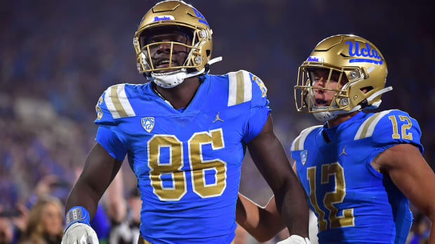 Nov 19, 2022; Pasadena, California, USA; UCLA Bruins tight end Michael Ezeike (86) celebrates his touchdown scored against the Southern California Trojans with wide receiver Matt Sykes (12) during the second half at the Rose Bowl. Mandatory Credit: Gary A. Vasquez-USA TODAY Sports  