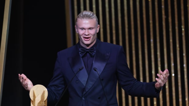 Erling Haaland pictured speaking on stage at the 2023 Ballon d'Or awards ceremony, where he was beaten to the main prize by Lionel Messi but received the Gerd Muller Trophy for being the Striker of the Year