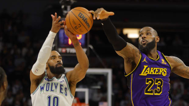 Dec 30, 2023; Minneapolis, Minnesota, USA; Los Angeles Lakers forward LeBron James (23) knocks the ball as Minnesota Timberwolves guard Mike Conley (10) shoots in the fourth quarter at Target Center.