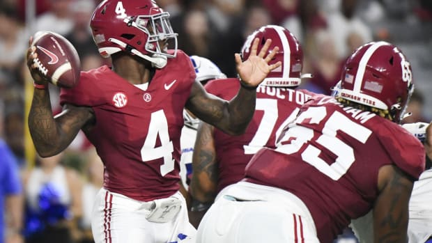 Sep 2, 2023; Tuscaloosa, Alabama, USA; Alabama Crimson Tide quarterback Jalen Milroe (4) throws behind a block by offensive lineman JC Latham (65) against the Middle Tennessee Blue Raiders during the first half at Bryant-Denny Stadium.