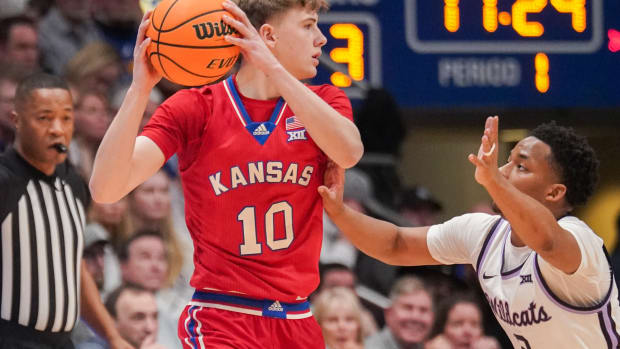 Mar 5, 2024; Lawrence, Kansas, USA; Kansas Jayhawks guard Johnny Furphy (10) looks to pass as Kansas State Wildcats guard Tylor Perry (2) defends during the first half at Allen Fieldhouse. Mandatory Credit: Denny Medley-USA TODAY Sports  