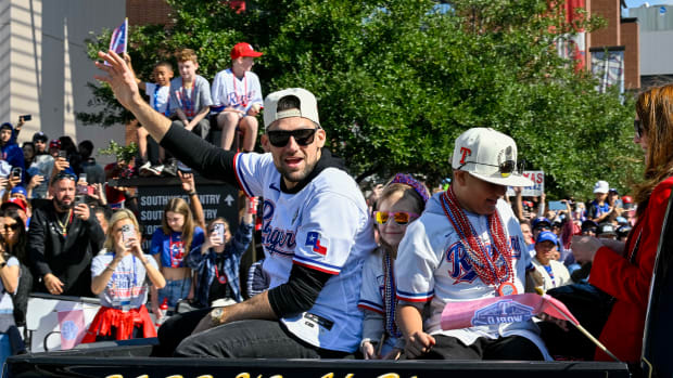 Texas Rangers starting pitcher Nathan Eovaldi celebrates during the World Series championship parade at Globe Life Field in November.