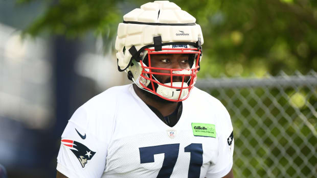 Jul 29, 2022; Foxborough, MA, USA; New England Patriots guard Mike Onwenu (71) walks onto the field during training camp at Gillette Stadium. Mandatory Credit: Brian Fluharty-USA TODAY Sports  