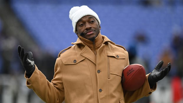 ESPN college football and NFL analyst Robert Griffin III reacts on the sidelines before a 2024 AFC divisional round game between the Houston Texans and the Baltimore Ravens at M&T Bank Stadium.
