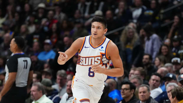 Phoenix Suns guard Grayson Allen (8) reacts following his three point basket in the first quarter against the Denver Nuggets at Ball Arena.