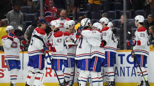Mar 5, 2024; Nashville, Tennessee, USA; Montreal Canadiens players celebrate after the game-winning goal by center Nick Suzuki (14) in overtime against the Nashville Predators at Bridgestone Arena. Mandatory Credit: Christopher Hanewinckel-USA TODAY Sports