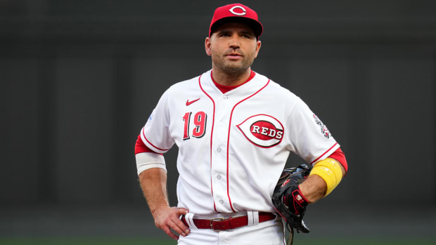 Joey Votto talks with an umpire during a game against the Twins.