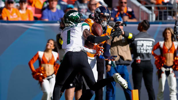 Oct 23, 2022; Denver, Colorado, USA; New York Jets cornerback Sauce Gardner (1) breaks up a pass intended for Denver Broncos wide receiver Courtland Sutton (14) in the second quarter at Empower Field at Mile High.