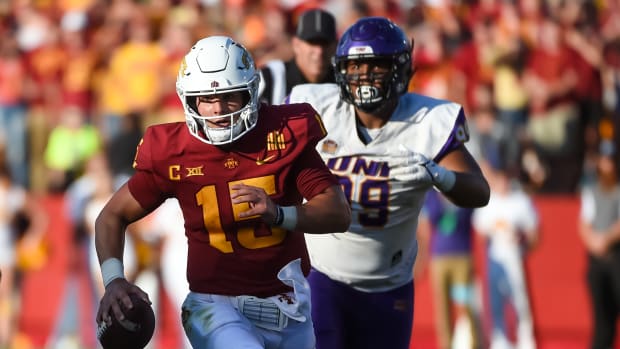 Sep 4, 2021; Ames, Iowa, USA; Iowa State Cyclones quarterback Brock Purdy (15) runs from Northern Iowa Panthers defensive lineman Khristian Boyd (99) in the second half at Jack Trice Stadium.