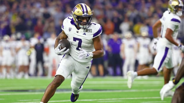Jan 8, 2024; Houston, TX, USA; Washington Huskies running back Dillon Johnson (7) runs with the ball against the Michigan Wolverines during the second quarter in the 2024 College Football Playoff national championship game at NRG Stadium.