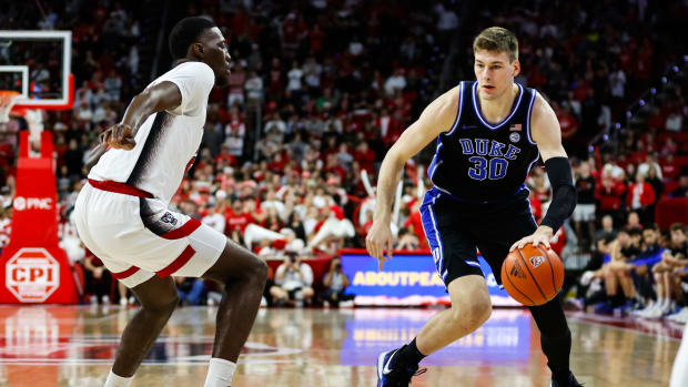 Mar 4, 2024; Raleigh, North Carolina, USA; Duke Blue Devils center Kyle Filipowski (30) dribbles with the ball guarded by North Carolina State Wolfpack guard Jordan Snell (22) during the first half against at PNC Arena. Mandatory Credit: Jaylynn Nash-USA TODAY Sports