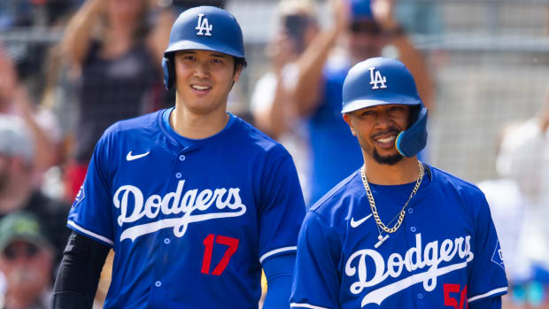 Dodgers designated hitter Shohei Ohtani, left, and second baseman Mookie Betts on the field during spring training
