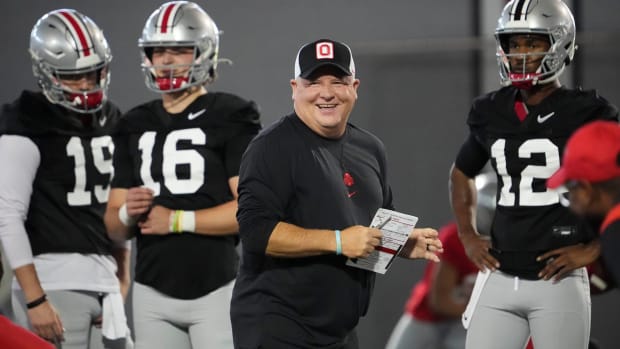 Ohio State offensive coordinator Chip Kelly smiles while coaching the quarterbacks during a practice.