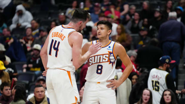 Phoenix Suns forward Drew Eubanks (14) and guard Grayson Allen (8) celebrate defeating the Denver Nuggets in the second half at Ball Arena.