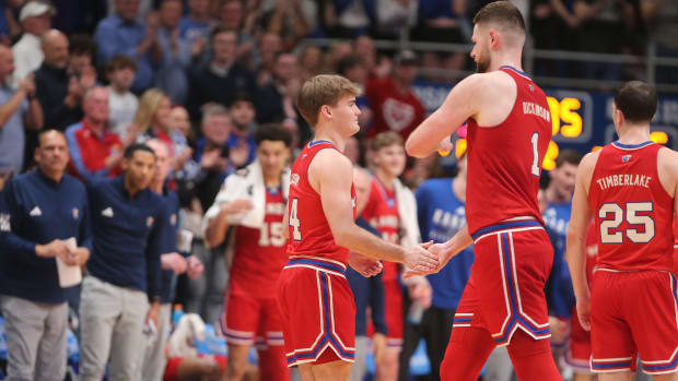 Kansas junior guard Patrick Cassidy (14) slaps hands with senior center Hunter Dickinson as he enters the court in the last minute in the second half of the Sunflower Showdown inside Allen Fieldhouse Tuesday, March 5, 2024.  