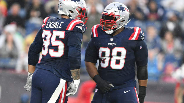 Aug 10, 2023; Foxborough, Massachusetts, USA; New England Patriots defensive tackle Daniel Ekuale (95) celebrates with defensive tackle Carl Davis Jr. (98) after sack against the Houston Texans during the first half at Gillette Stadium.