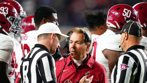 Nov 25, 2023; Auburn, Alabama, USA; Alabama Crimson Tide head coach Nick Saban listens to referee Jason Autrey during the fourth quarter at Jordan-Hare Stadium. Mandatory Credit: John David Mercer-USA TODAY Sports