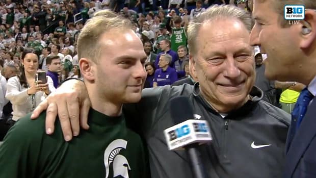 Michigan State head coach Tom Izzo and his son, Michigan State guard Steven Izzo, speak with Andy Katz after a win on senior night.