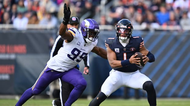 Oct 15, 2023; Chicago, Illinois, USA; Chicago Bears quarterback Justin Fields (1) is pursued by Minnesota Vikings linebacker Danielle Hunter (99) in the second half at Soldier Field.