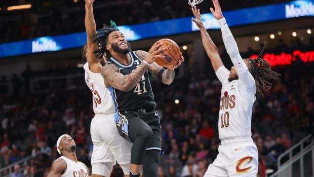 Mar 6, 2024; Atlanta, Georgia, USA; Atlanta Hawks forward Saddiq Bey (41) shoots past Cleveland Cavaliers forward Isaac Okoro (35) and guard Darius Garland (10) in the second half at State Farm Arena. Mandatory Credit: Brett Davis-USA TODAY Sports