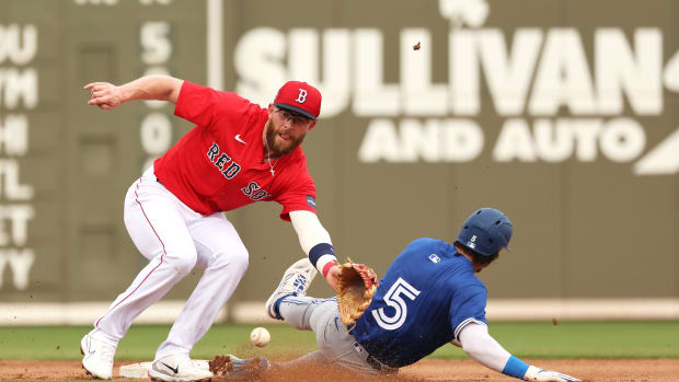 Mar 3, 2024; Fort Myers, Florida, USA; Toronto Blue Jays second baseman Santiago Espinal (5) sides safe into second base as Boston Red Sox shortstop Trevor Story (10) attempted to tag him out during the fourth inning at JetBlue Park at Fenway South.