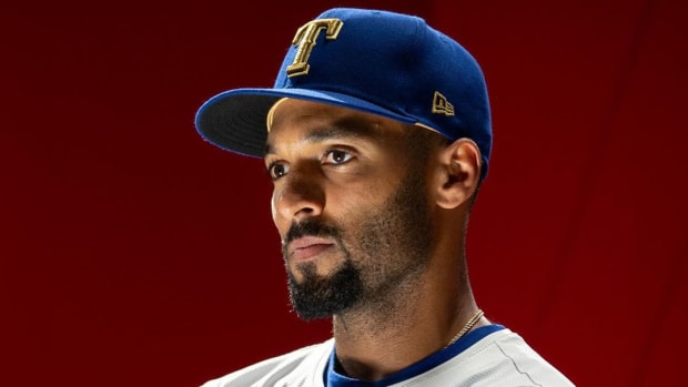Texas Rangers second baseman Marcus Semien models the club's gold-trimmed uniforms to help celebrate their first World Series championship in 2023.