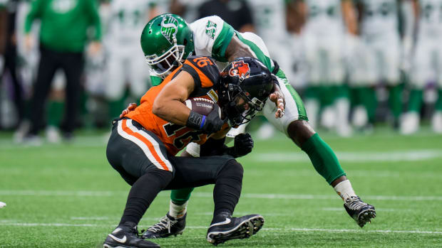 Aug 26, 2022; Vancouver, British Columbia, CAN; Saskatchewan Roughriders linebacker Larry Dean (11) tackles BC Lions wide receiver Bryan Burnham (16) in the first half at BC Place. Mandatory Credit: Bob Frid-USA TODAY Sports  