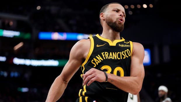 Golden State Warriors guard Stephen Curry (30) reacts after recording an assist against the Milwaukee Bucks in the third quarter at the Chase Center.