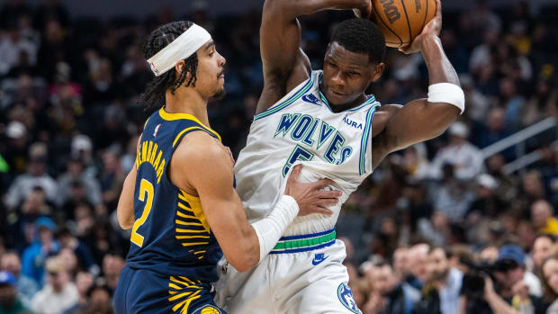 Mar 7, 2024; Indianapolis, Indiana, USA; Minnesota Timberwolves guard Anthony Edwards (5) holds the ball while Indiana Pacers guard Andrew Nembhard (2) defends during the first half at Gainbridge Fieldhouse.