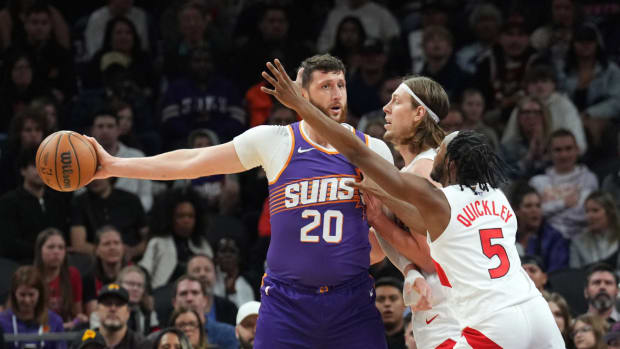 Phoenix Suns center Jusuf Nurkic (20) protects the ball from Toronto Raptors forward Kelly Olynyk (41) and Toronto Raptors guard Immanuel Quickley (5) during the first half at Footprint Center.