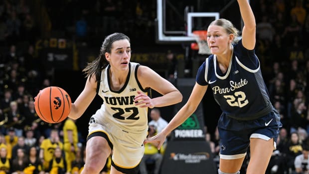 Iowa Hawkeyes guard Caitlin Clark (22) controls the ball as Penn State Nittany Lions guard Alli Campbell (22) defends during the second half at Carver-Hawkeye Arena.