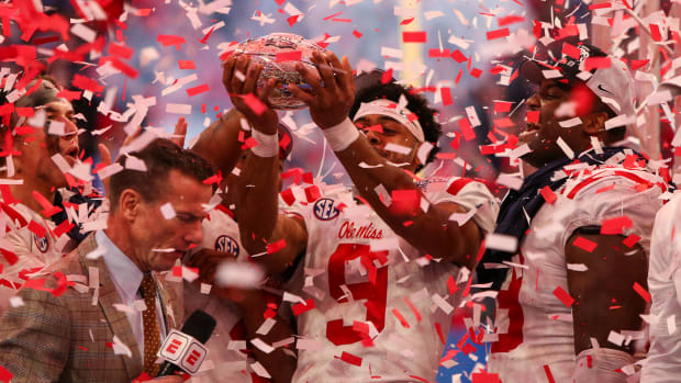 Dec 30, 2023; Atlanta, GA, USA; Mississippi Rebels wide receiver Tre Harris (9) holds up the Peach Bowl trophy after a victory against the Penn State Nittany Lions at Mercedes-Benz Stadium. Mandatory Credit: Brett Davis-USA TODAY Sports