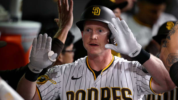 Sep 18, 2023; San Diego, California, USA; San Diego Padres first baseman Garrett Cooper (24) celebrates in the dugout after hitting a two-run home run against the Colorado Rockies during the second inning at Petco Park. Mandatory Credit: Orlando Ramirez-USA TODAY Sports