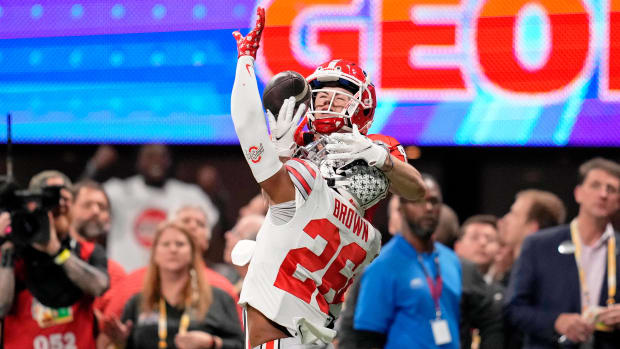Dec 31, 2022; Atlanta, Georgia, USA; Ohio State Buckeyes cornerback Cameron Brown (26) breaks up a pass intended for Georgia Bulldogs wide receiver Ladd McConkey (84) during the fourth quarter of the 2022 Peach Bowl at Mercedes-Benz Stadium. Mandatory Credit: Dale Zanine-USA TODAY Sports  