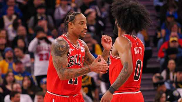 Chicago Bulls forward DeMar DeRozan (11) high fives guard Coby White (0) after a play against the Golden State Warriors during the fourth quarter at Chase Center.
