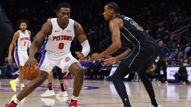 Detroit Pistons center Jalen Duren (0) dribbles defended by Brooklyn Nets center Nic Claxton (33) in the first half at Little Caesars Arena.