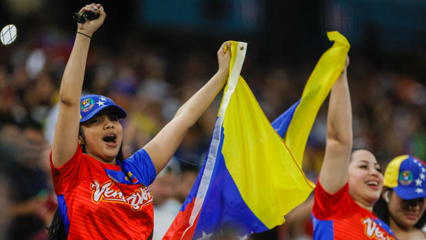 Mar 14, 2023; Miami, Florida, USA; Baseball fans cheer for Venezuela while waving a flag during the game against Nicaragua at LoanDepot Park.