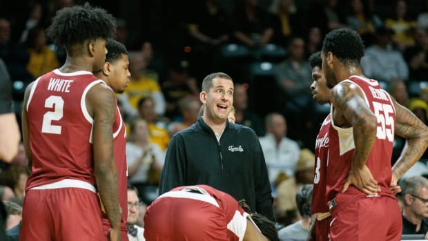 Temple's basketball coach talks to his players on the sideline