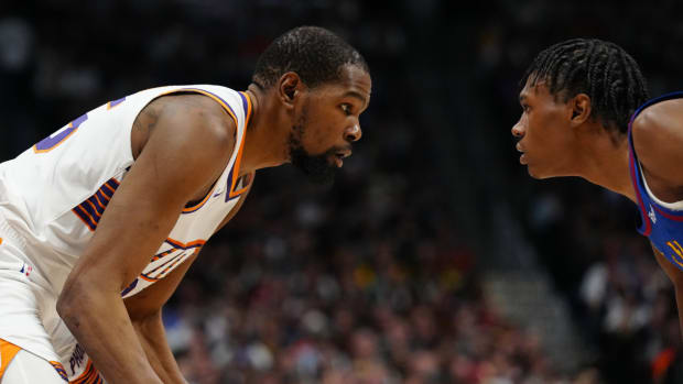 Phoenix Suns forward Kevin Durant (35) faces off across from Denver Nuggets forward Peyton Watson (8) in the second half at Ball Arena.