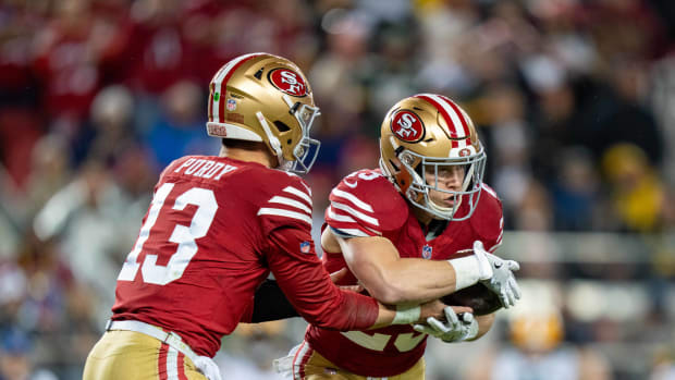 January 20, 2024; Santa Clara, CA, USA; San Francisco 49ers running back Christian McCaffrey (23) receives the hand off from quarterback Brock Purdy (13) during the second quarter in a 2024 NFC divisional round game against the Green Bay Packers at Levi's Stadium. Mandatory Credit: Kyle Terada-USA TODAY Sports  