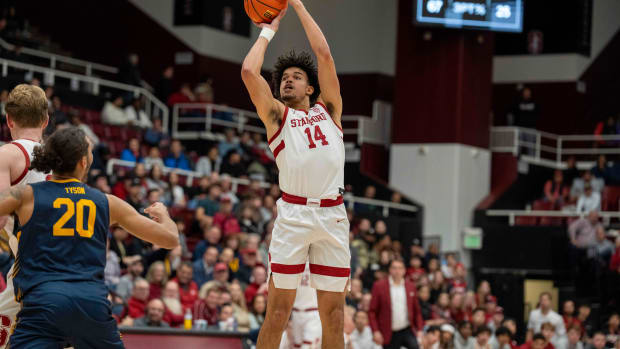 Mar 7, 2024; Stanford, California, USA; Stanford Cardinal forward Spencer Jones (14) shoots a three point basket against California Golden Bears guard Jaylon Tyson (20) during the first half at Maples Pavillion. Mandatory Credit: Neville E. Guard-USA TODAY Sports