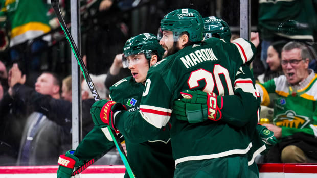 Jan 15, 2024; Saint Paul, Minnesota, USA; Minnesota Wild center Connor Dewar (26) celebrates his goal with left wing Pat Maroon (20) during the second period against the New York Islanders at Xcel Energy Center.