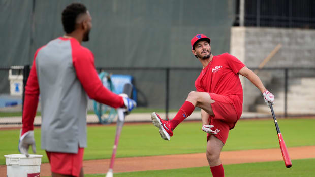 Feb 16, 2024; Clearwater, FL, USA; Philadelphia Phillies catcher Garrett Stubbs (21) jokes with teammates during a bunting drill at Phillies Spring Training.