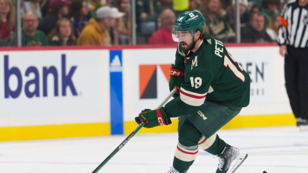 Sep 28, 2023; Saint Paul, Minnesota, USA; Minnesota Wild center Nic Petan (19) skates with the puck against the Colorado Avalanche in the second period at Xcel Energy Center.