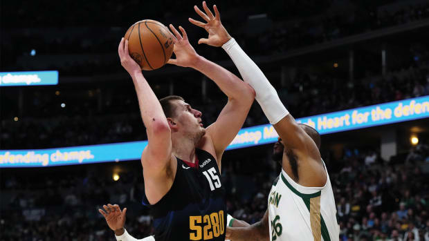 Boston Celtics forward Xavier Tillman defends Denver Nuggets center Nikola Jokić.