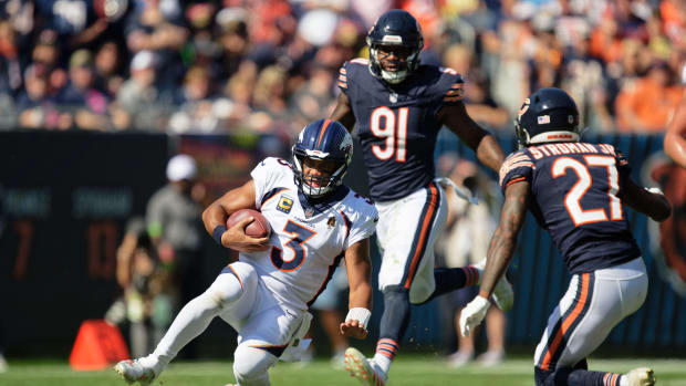 Russell Wilson slides after scrambling against the Bears in Denver's comeback win at Soldier Field last season.