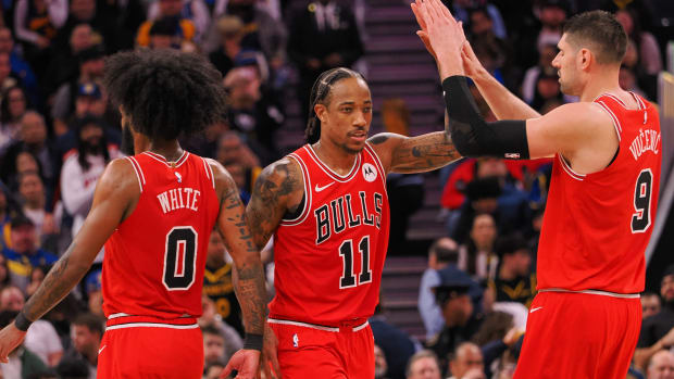  Chicago Bulls forward DeMar DeRozan (11) high fives guard Coby White (0) and center Nikola Vucevic (9) after a play against the Golden State Warriors during the fourth quarter at Chase Center.