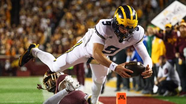 Oct 7, 2023; Minneapolis, Minnesota, USA; Michigan Wolverines quarterback J.J. McCarthy (9) dives for a touchdown against the Minnesota Golden Gophers during the second quarter at Huntington Bank Stadium. 